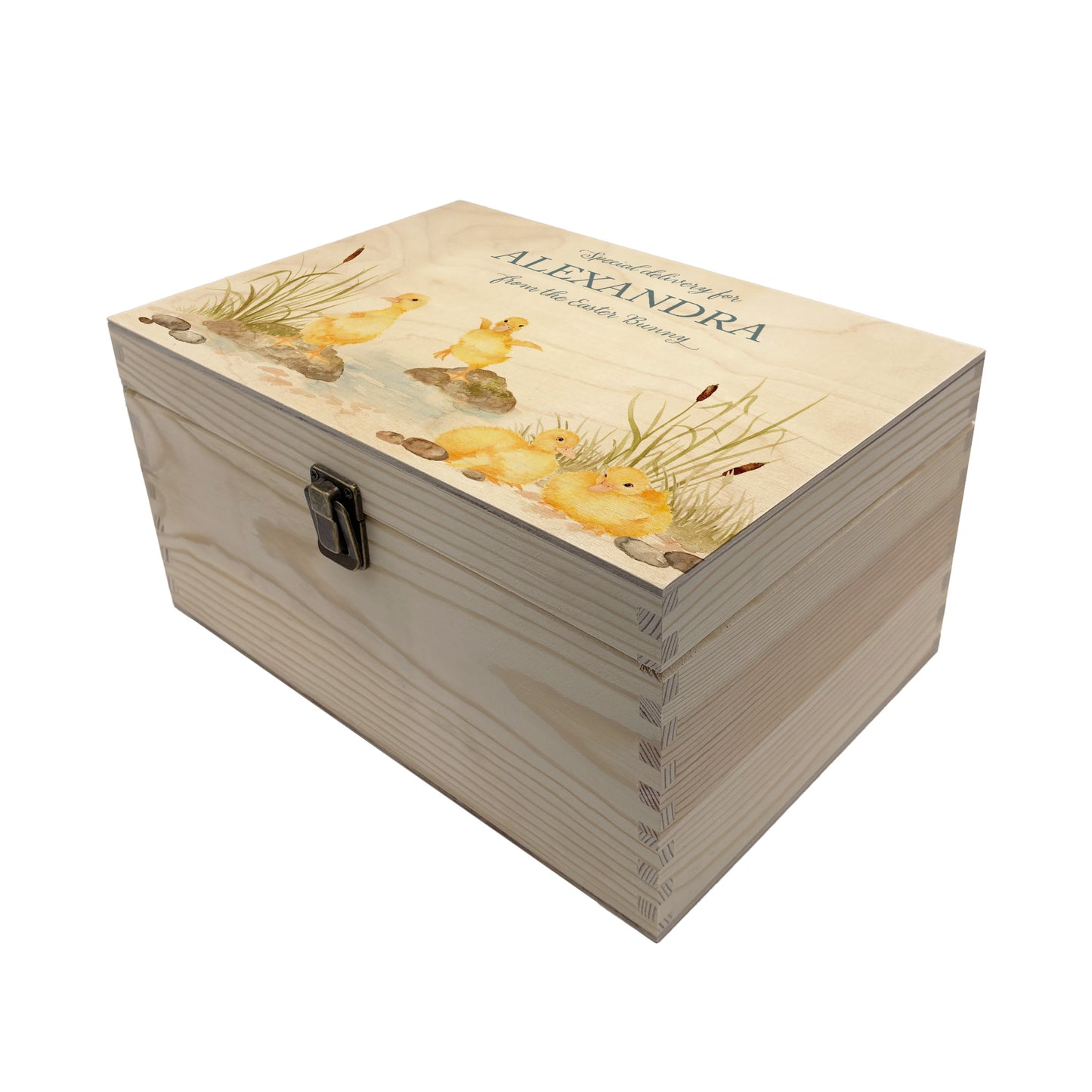 Small Easter personalised wooden pine box, perfect for Easter treats, eggs, gifting. Children gifts. This box has a beautiful easter theme with 4 fluffy ducklings playing in a pond area, surrounded by reeds and pebbles. This box can be personalised in 4 phrases or it can just have the design and no text. 