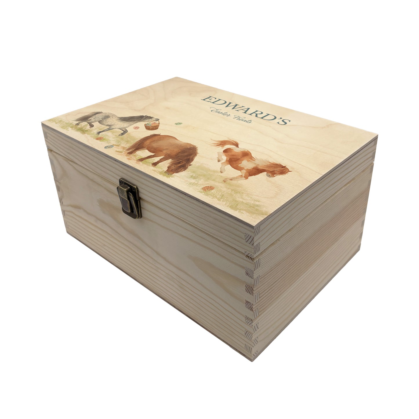 This Easter medium wooden gift box box has 3 Shetland ponies running around a spring meadow. One Shetland is swinging a bucket full of pastel easter eggs which has flung all over the meadow. another is bucking and having lots of fun another is grazing and the other is stood watching. These easter boxes are great for gifting and filling full of easter treats for your loved ones, children, parents and friends. Great keeps sake to keep. 