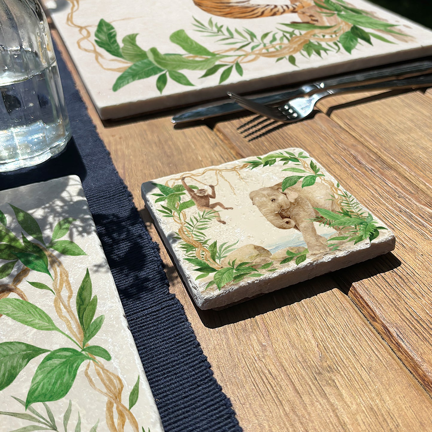 Welcoming our Rainforest Design, surrounded by the rainforest leaves and vines. Our Elephant and Gibbon swinging from the vines. Illustrated in our  original watercolour designs in a set of 4 coasters.  