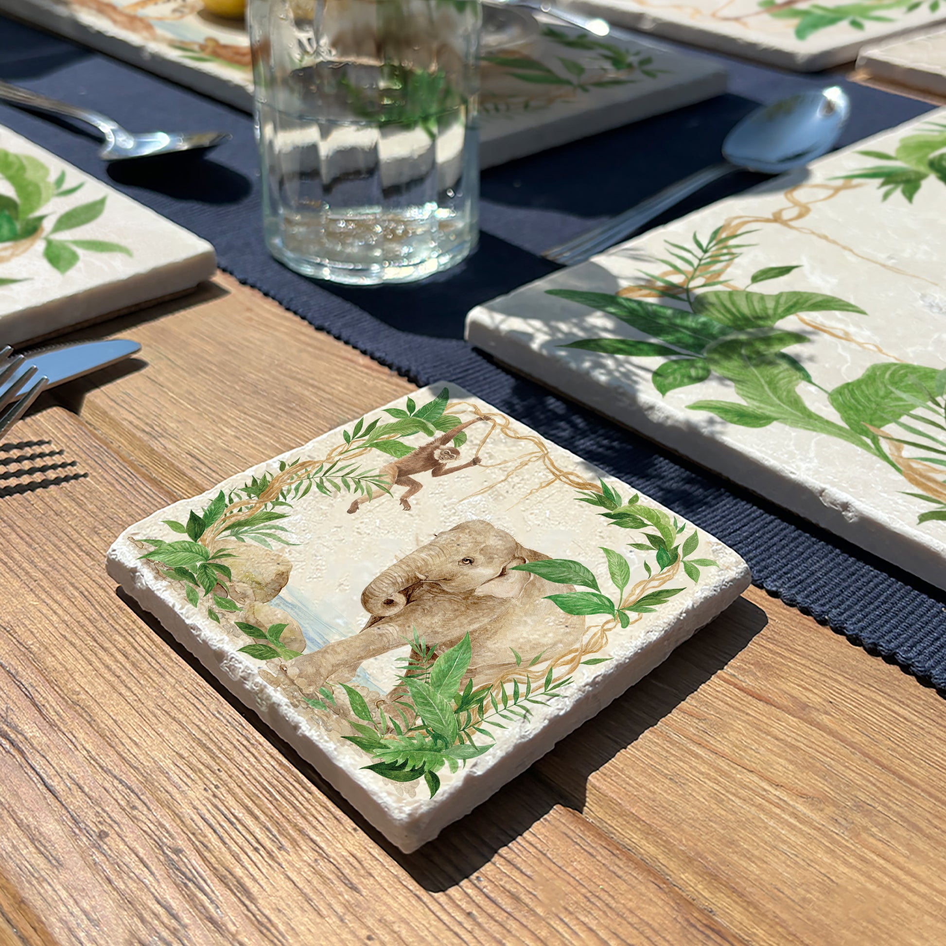 Welcoming our Rainforest Design, surrounded by the rainforest leaves and vines. Our Elephant and Gibbon swinging from the vines. Illustrated in our  original watercolour designs in a set of 4 coasters.  
