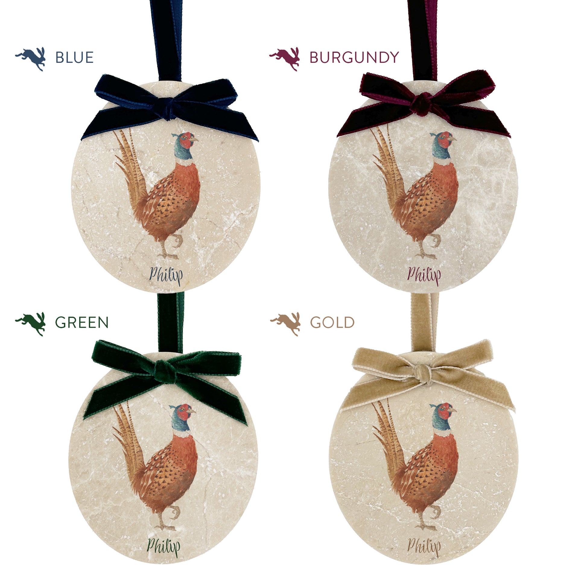 Four personalised oval shaped marble baubles showing a selection of velvet ribbon colour options. Choose from navy blue, burgundy red, forest green and champagne gold.