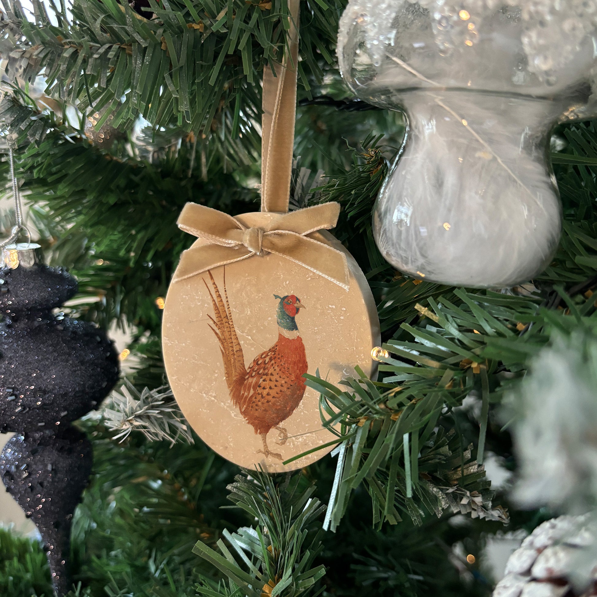 Celebrate the season in style with our oval-shaped marble baubles, featuring exquisite watercolour designs of countryside animals. Each bauble is finished with a velvet ribbon in your preferred colour and can be personalised to make your holiday décor truly unique.