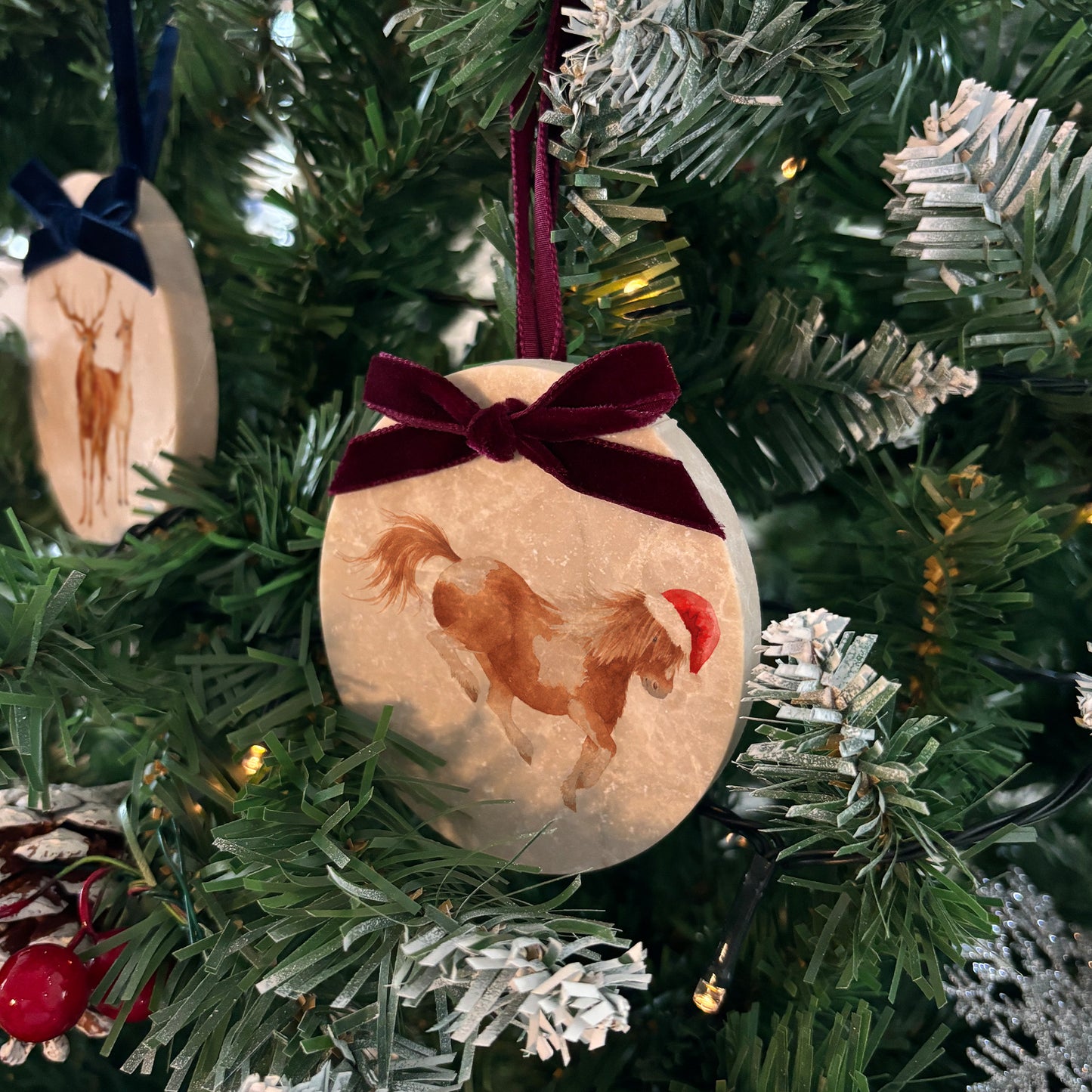 Celebrate the season in style with our oval-shaped marble baubles, featuring exquisite watercolour designs of countryside animals. Each bauble is finished with a velvet ribbon in your preferred colour and can be personalised to make your holiday décor truly unique.