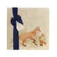 A multipurpose marble platter with a fox and fox cub design, packaged with a luxurious dark blue bow and branded gift tag.