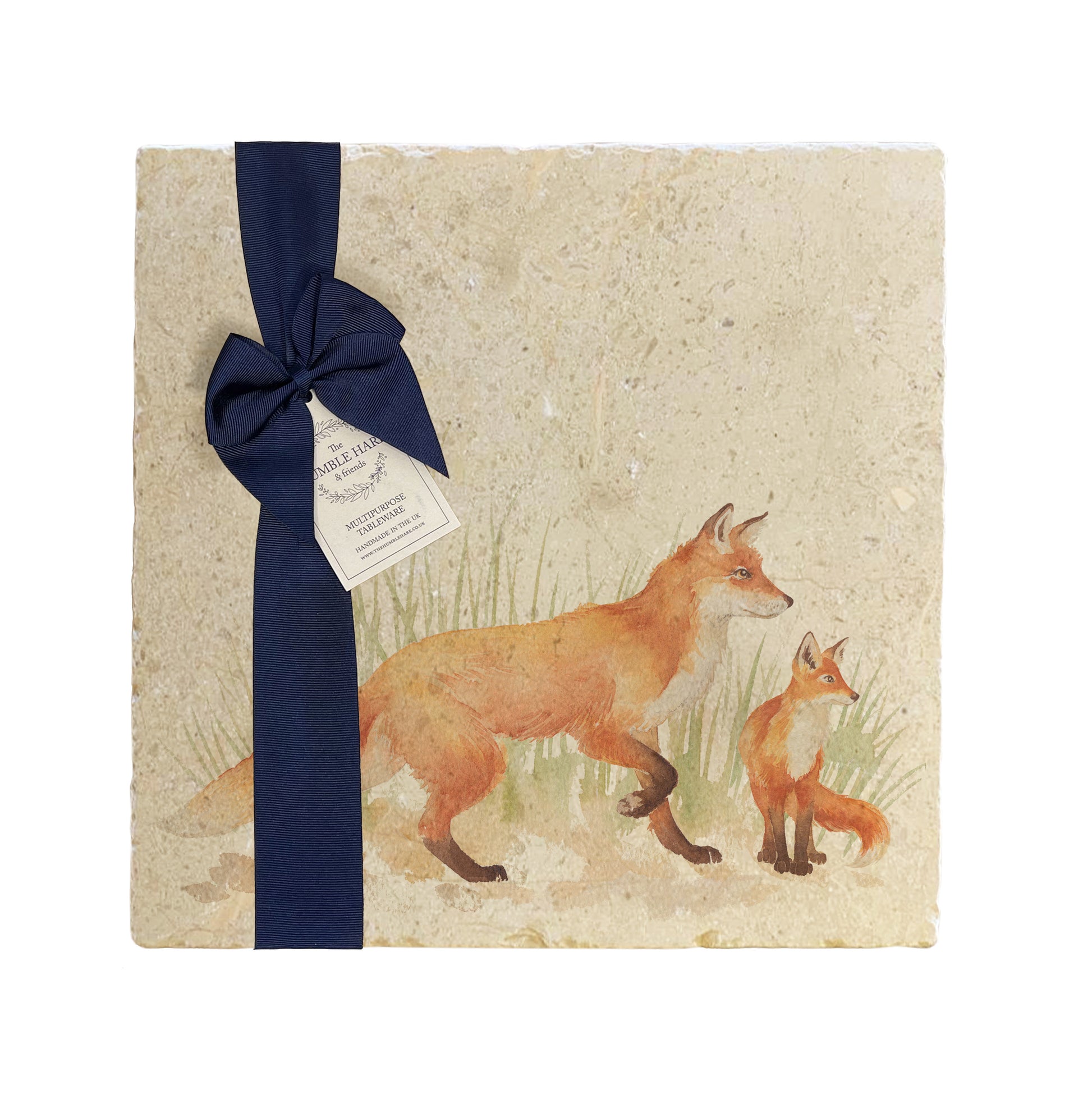 A multipurpose marble platter with a fox and fox cub design, packaged with a luxurious dark blue bow and branded gift tag.