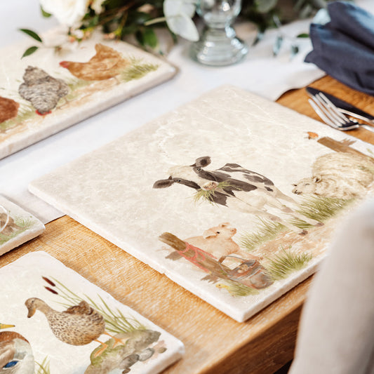 A set of mix and match marble platters with farmyard animal designs.