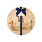 Round beech wood chopping board featuring full of farm animals, including the dairy cow, grazing horse, sheep, piglets, ducklings and chicken. The wooden board is finished with a blue gift ribbon and tag.
