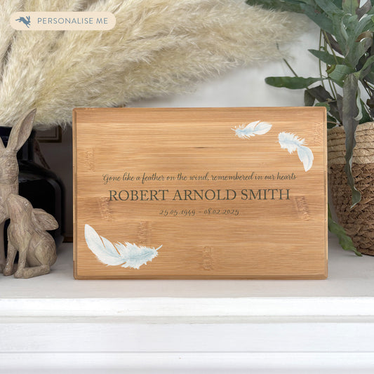 A beautifully crafted solid Bamboo wooden urn, personalised and finished with a soft watercolour Feather design, Thoughtfully made for either display or burial, this personalised urn can be customised to create a meaningful memorial. Perfect for holding ashes of a loved one or a beloved pet, it serves as a comforting tribute and keepsake. 