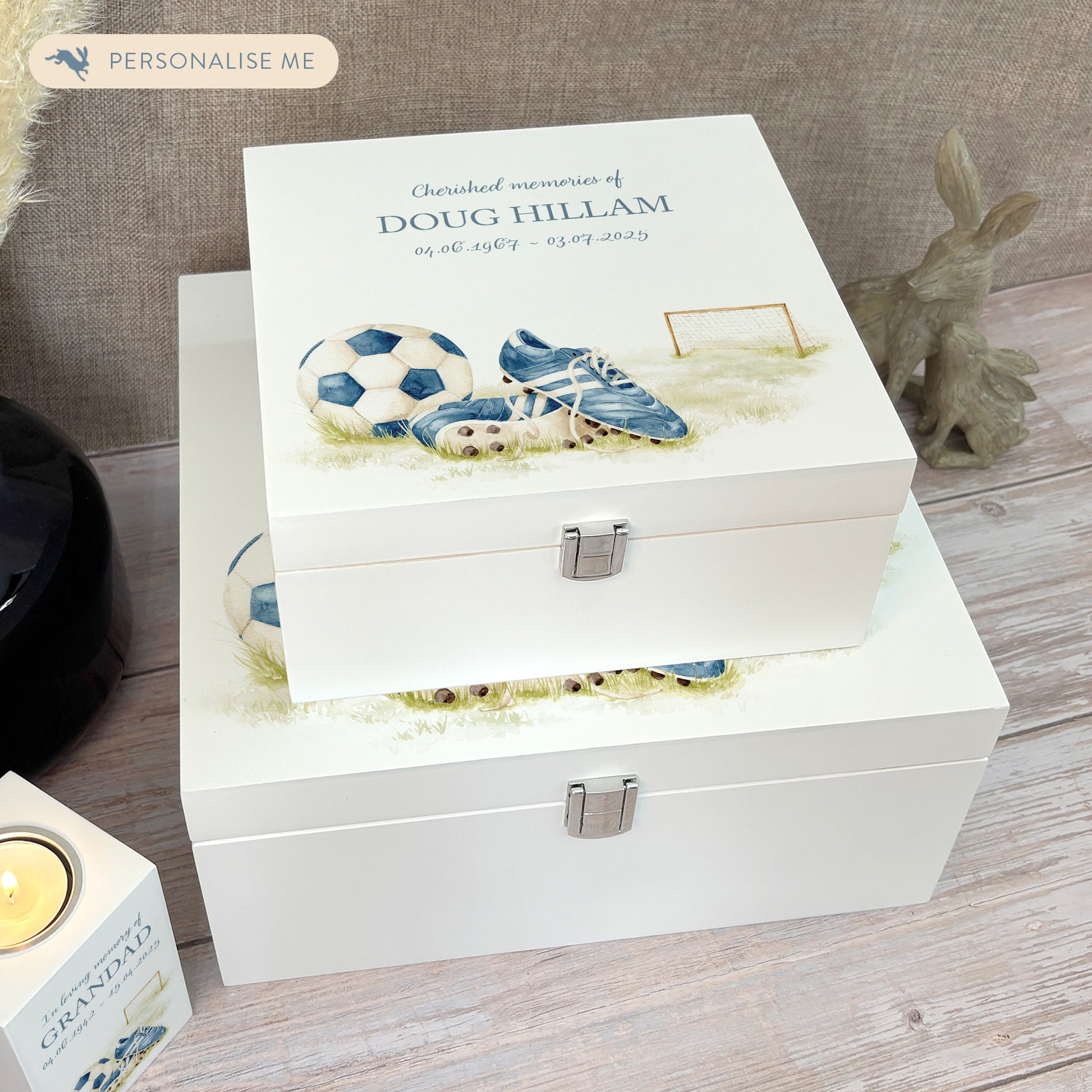 White Square personalised Wooden box with a decorative lid featuring illustrations of a pair of football boots in blue, a goal and football. Perfect funeral memory keepsake box, for storing ashes, order of service, flowers and capturing your loved ones things in one place. 