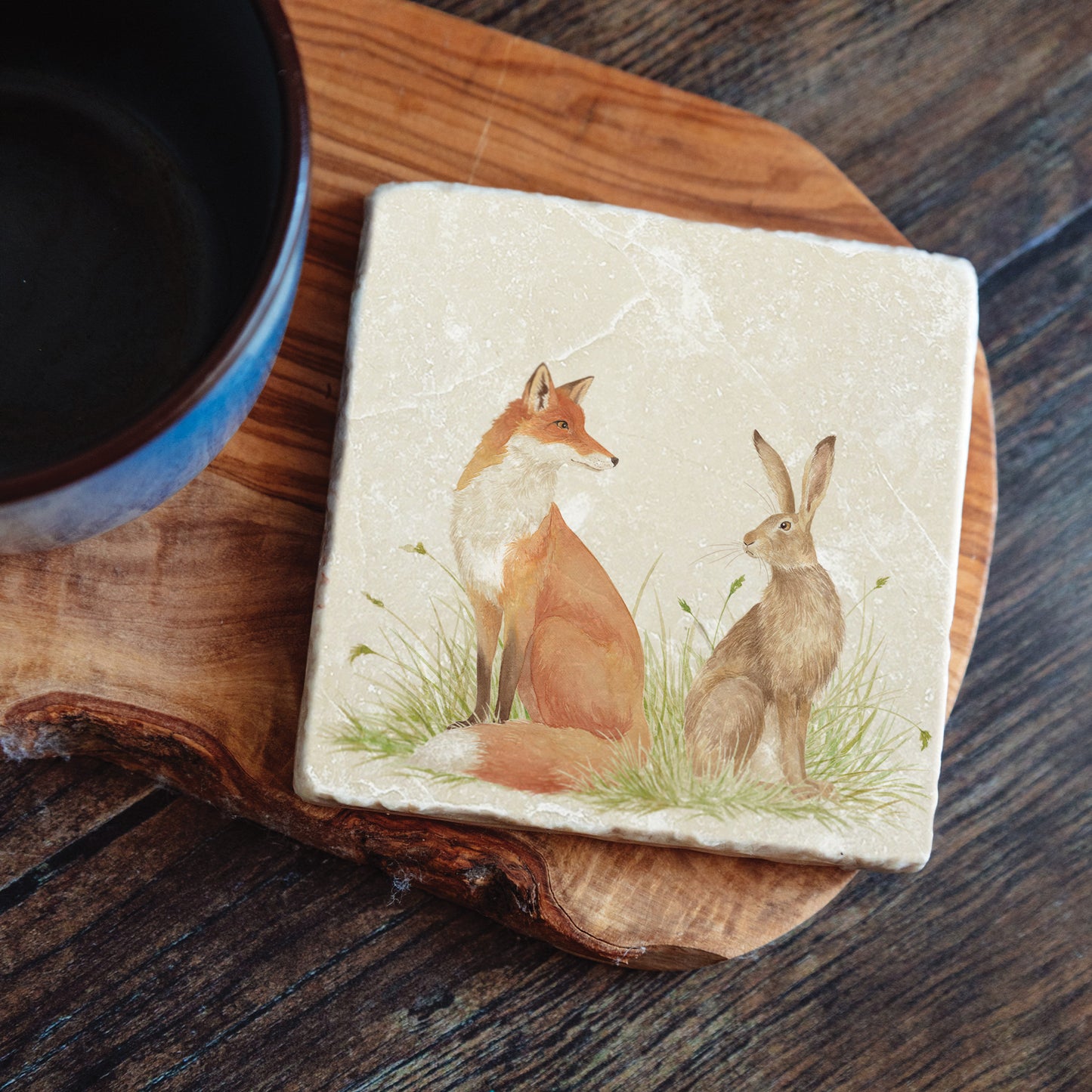 Water colour design featuring a Fox and Hare on a set of 4 coasters  Sat in a meadow style scenery. Some will question are they friend or Foe?