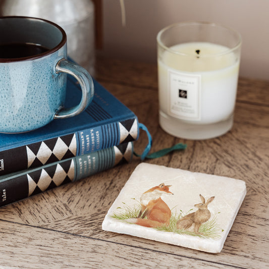 Water colour design featuring a Fox and Hare on a set of 4 coasters  Sat in a meadow style scenery. Some will question are they friend or Foe?