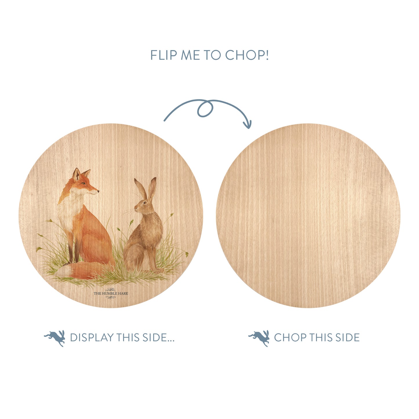 Wooden cutting board with a fox and hare illustration on one side and plain wood on the other, with text indicating which side to display and which to chop.
