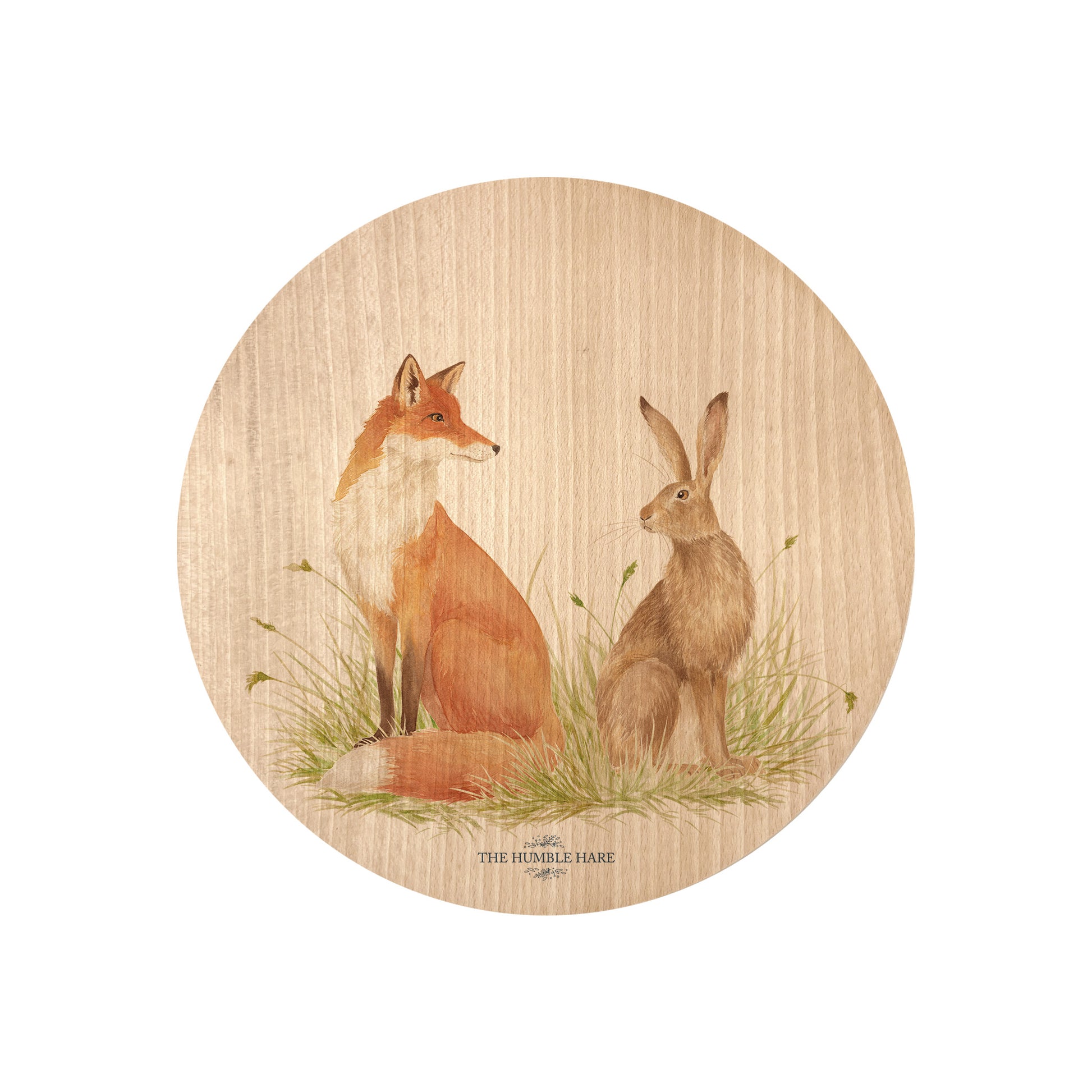 Round beech wood chopping board featuring a watercolour design of a fox and hare in a meadow.