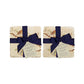 A set of 4 handmade marble coasters packaged in 2 pairs, with a luxurious dark blue bow and gift tag.