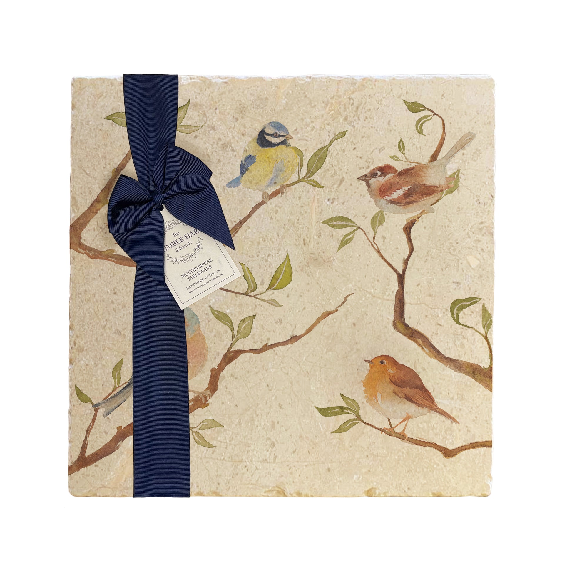 A multipurpose marble platter with a British garden birds on branches design, packaged with a luxurious dark blue bow and branded gift tag.