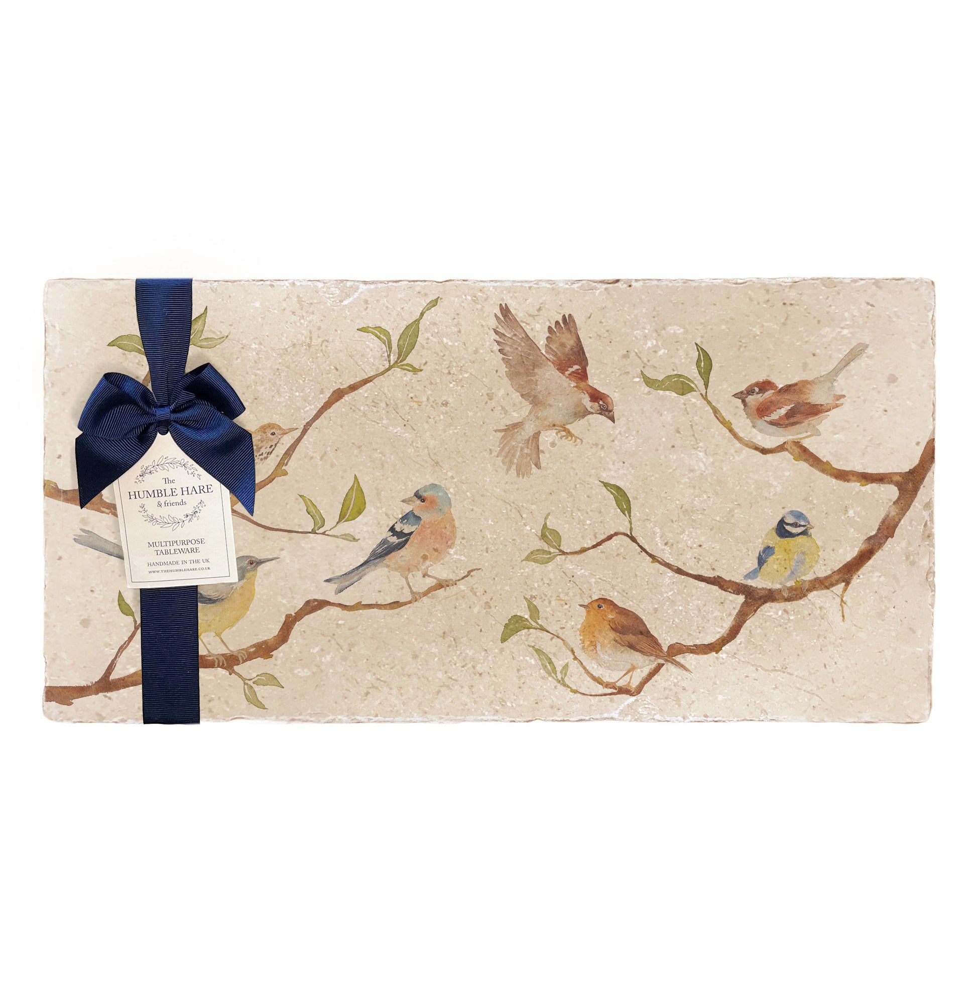 A multipurpose marble platter with a British garden birds on branches design, packaged with a luxurious dark blue bow and branded gift tag.