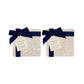 Dark blue ribbon and gift bows with Humble Hare paper tags, displayed on two sets of marble coasters.