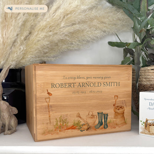 A beautifully crafted solid Bamboo wooden urn, personalised and finished with a soft watercolour design of a Gardening scene with wellies, vegetables and a robin sat on a spade. Perfect for the gardening lover Thoughtfully made for either display or burial, this personalised urn can be customised to create a meaningful memorial. Perfect for holding ashes of a loved one or a beloved pet, it serves as a comforting tribute and keepsake. 