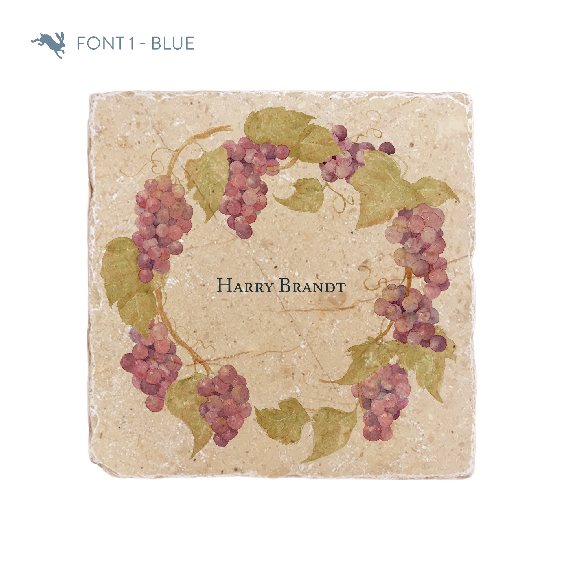 A medium marble platter featuring a wreath of grape vines and leaves, personalised with a bespoke name in the centre of the platter in a blue font.