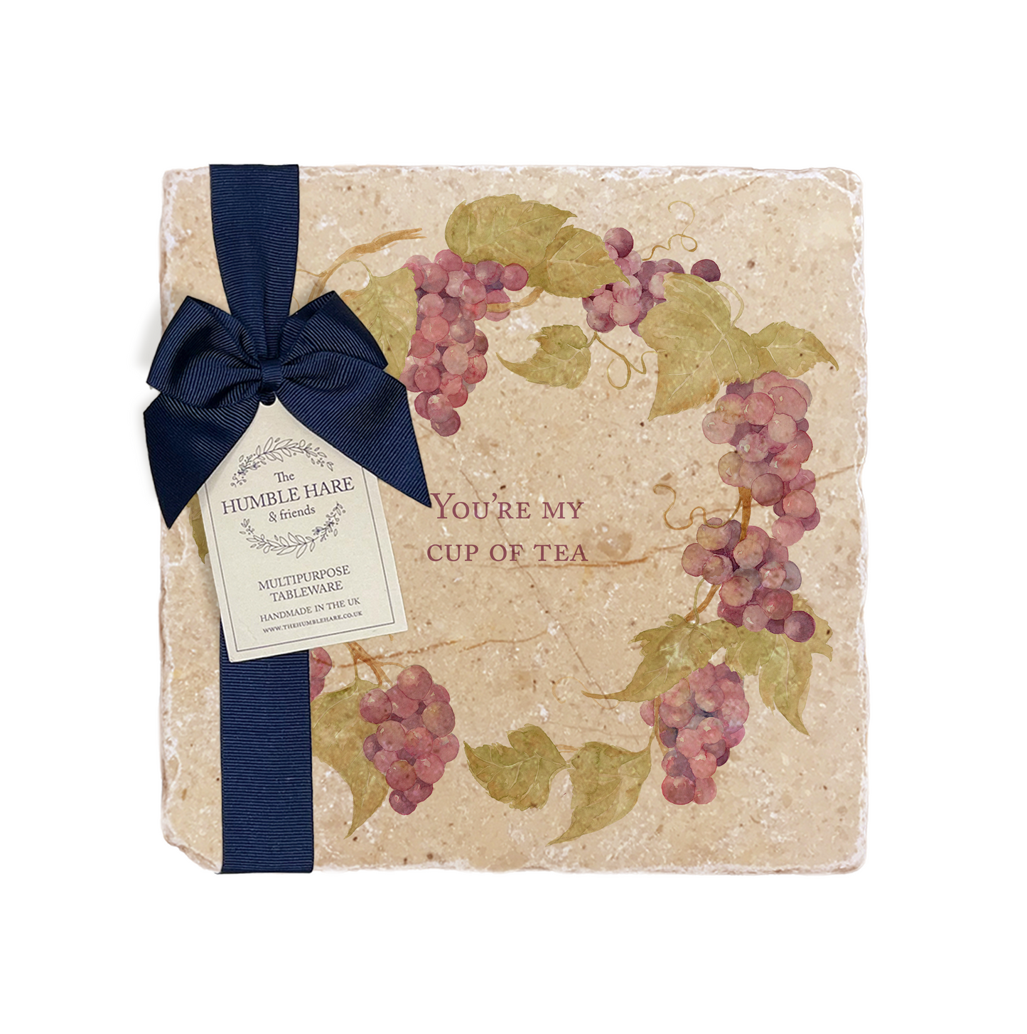 A personalised marble platter featuring a wreath of grape vines and leaves, with a bespoke message in the centre of the design. The platter is packaged with a luxurious blue gift bow and tag.