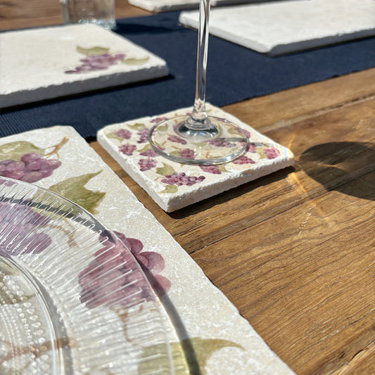 A square cream marble coaster featuring a watercolour grape vine pattern.