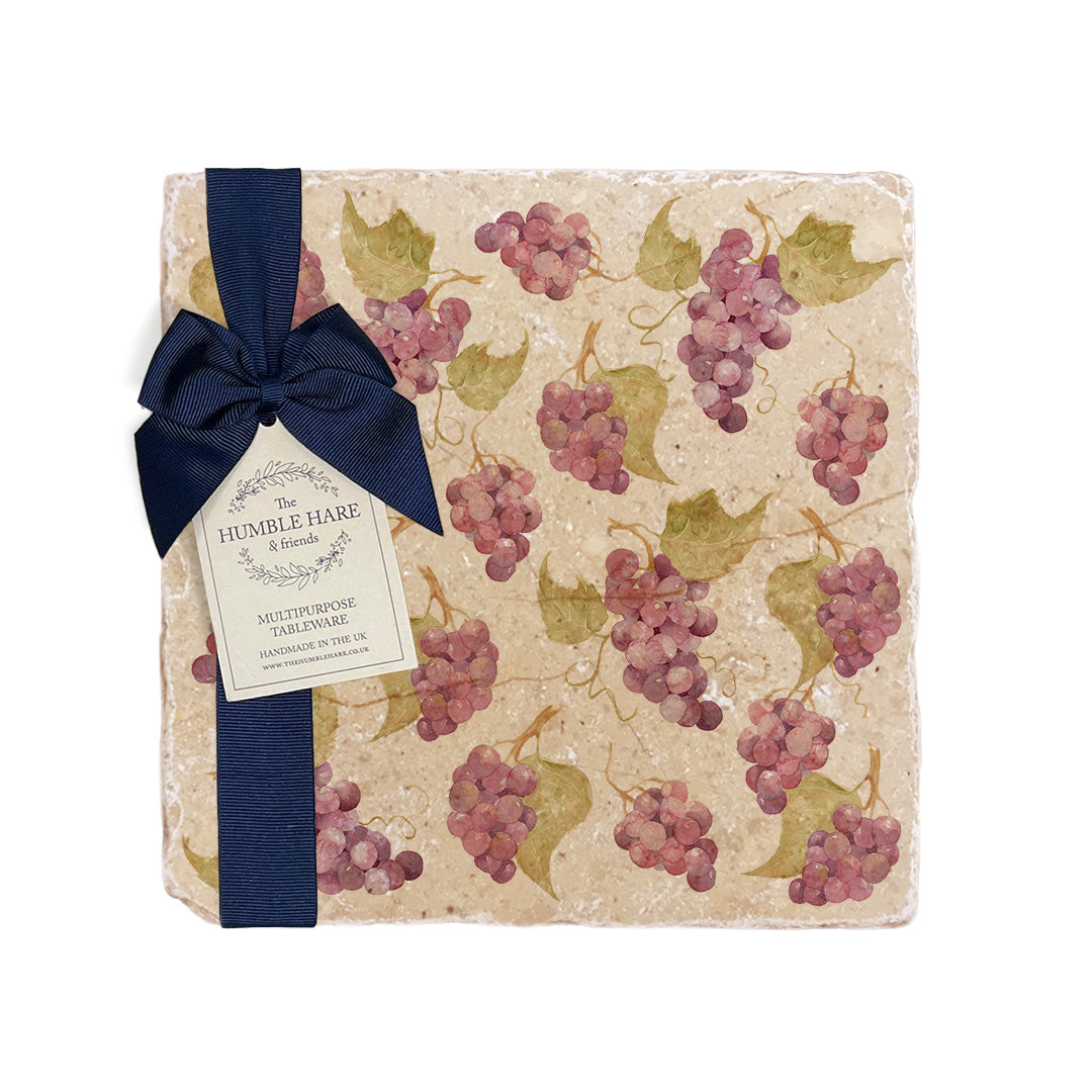 A medium multipurpose marble platter with a watercolour grape vine pattern, packaged with a luxurious dark blue bow and branded gift tag.