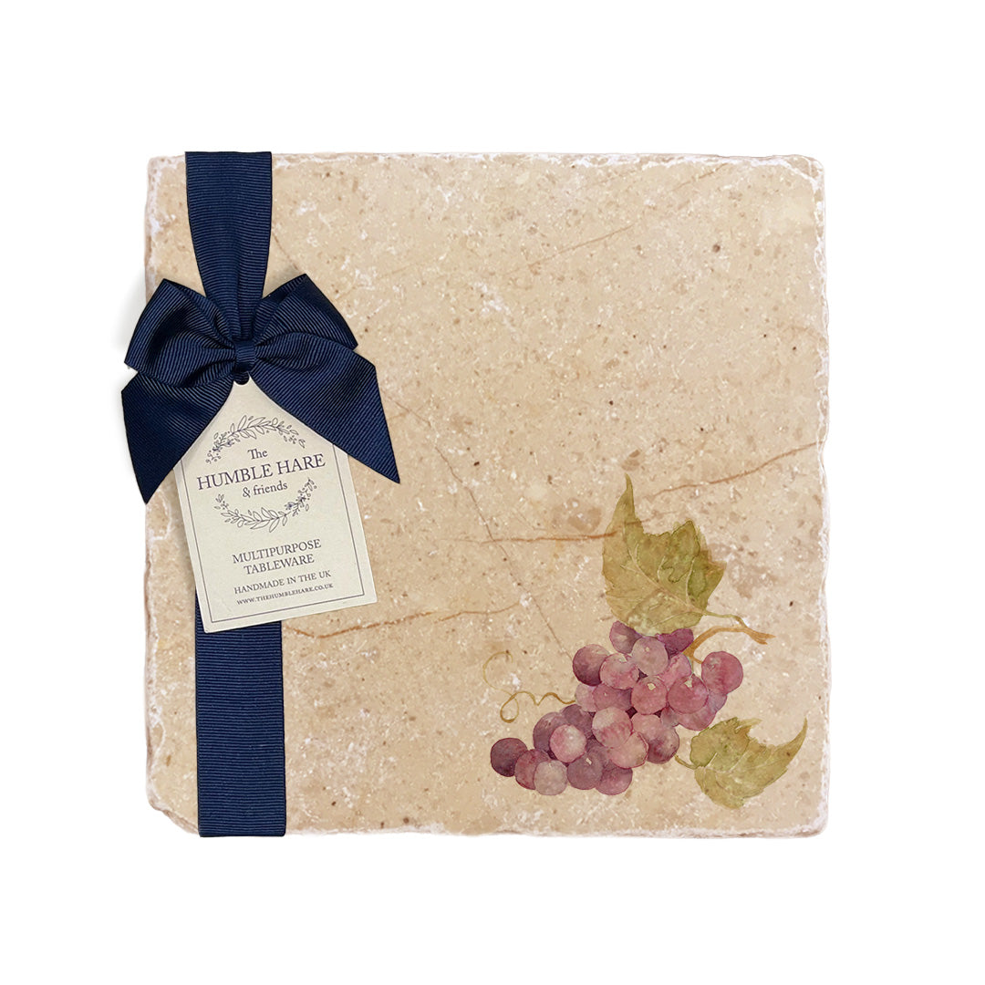 A medium multipurpose marble platter with a watercolour grape vine design, packaged with a luxurious dark blue bow and branded gift tag.