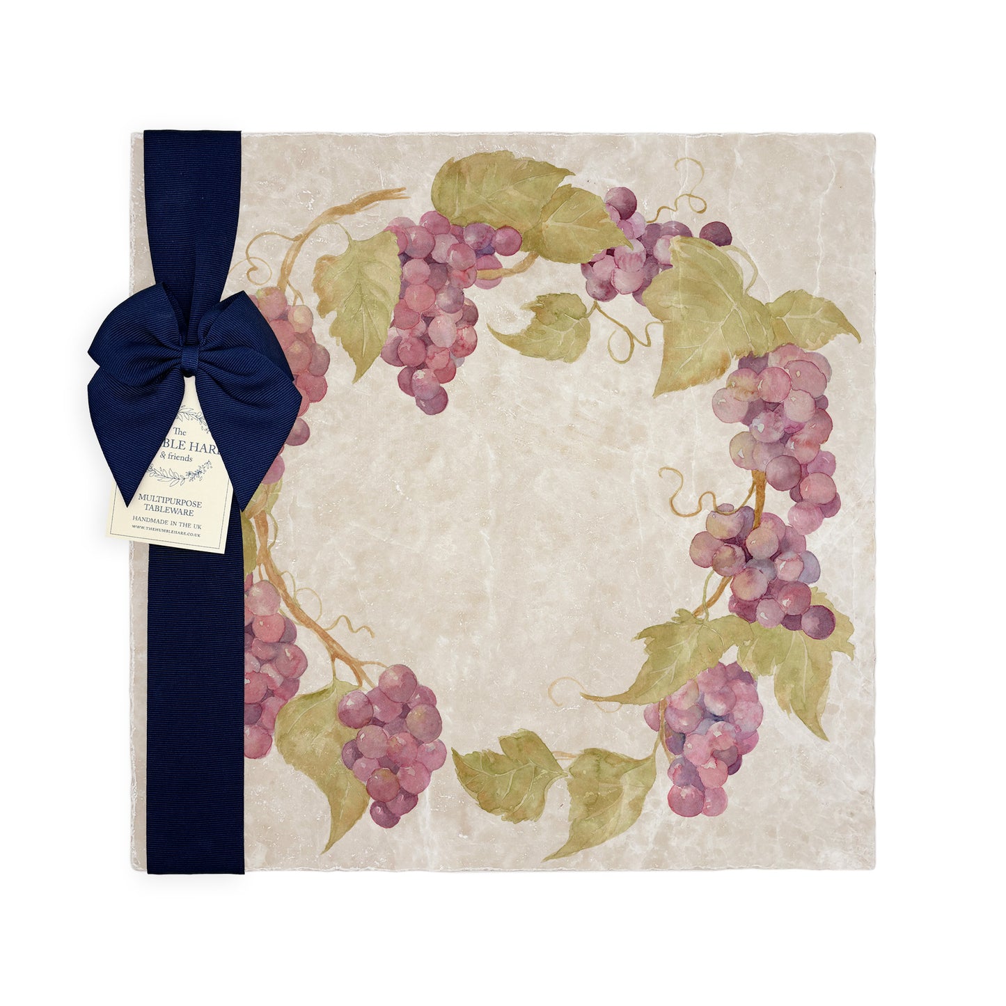 A large multipurpose marble platter with a watercolour grape vine wreath design, packaged with a luxurious dark blue bow and branded gift tag.