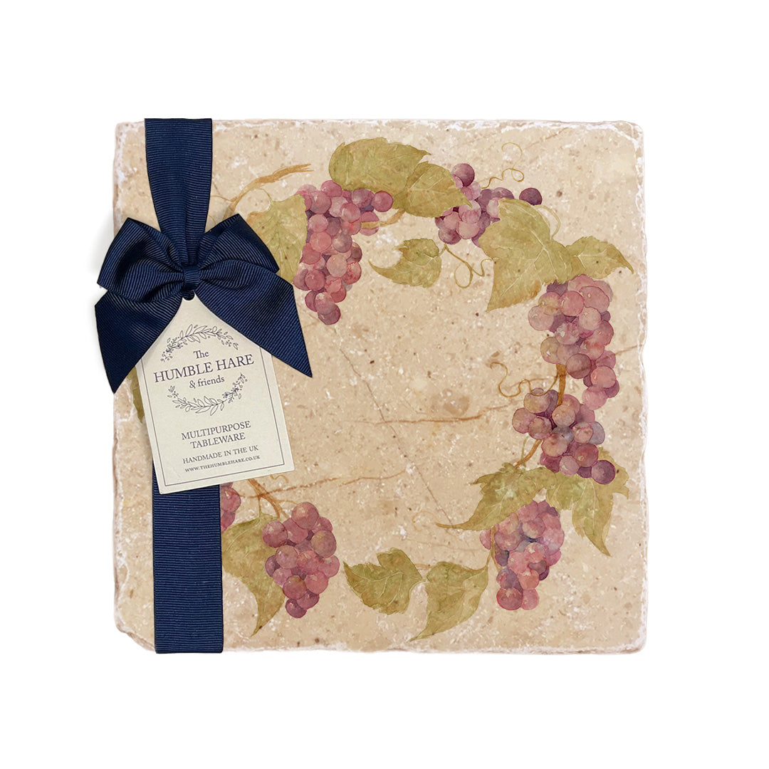 A medium multipurpose marble platter with a watercolour grape vine wreath design, packaged with a luxurious dark blue bow and branded gift tag.