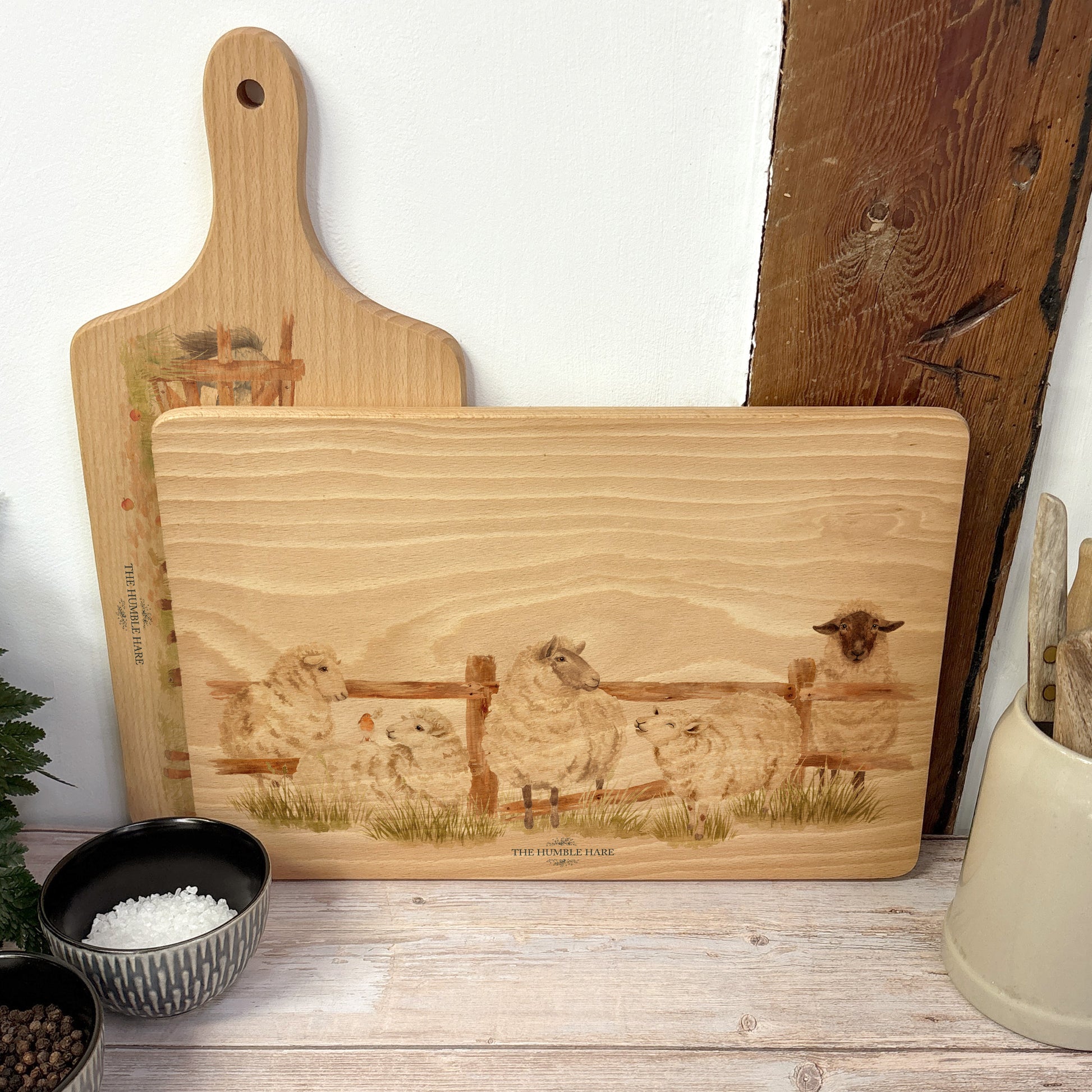 sheep breaking out from the field in a water colour style on our beech wooden chopping board 
