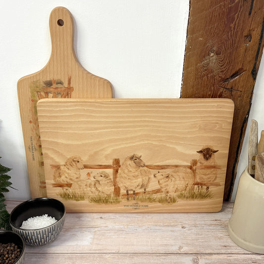 sheep breaking out from the field in a water colour style on our beech wooden chopping board 