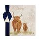 A large square personalised marble placemat with a highland cow and calf design. The placemat is packaged with a luxurious dark blue ribbon and The Humble Hare branded tag.