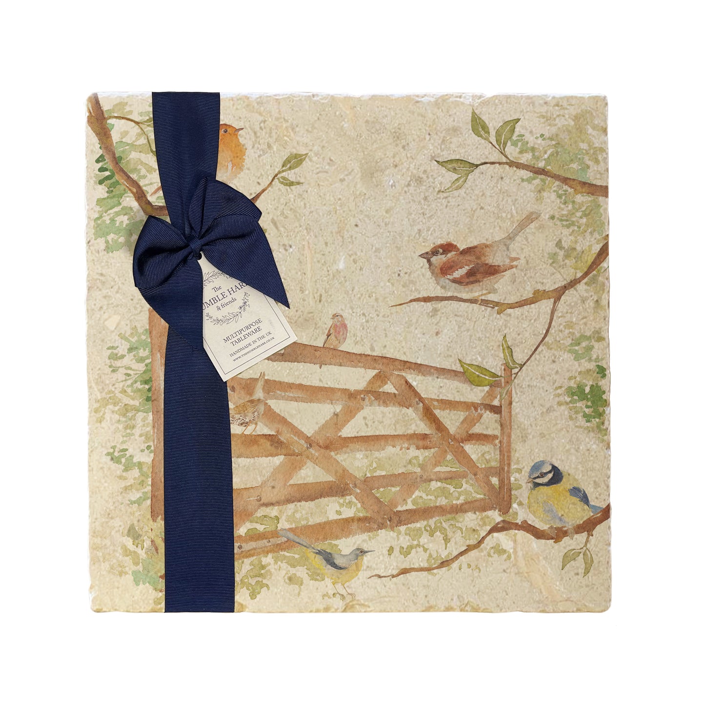 A multipurpose marble platter with a design featuring British garden birds in the hedgerow around the paddock gate, packaged with a luxurious dark blue bow and branded gift tag.