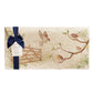 A multipurpose marble platter with a watercolour design featuring British garden birds in the hedgerow around the paddock gate, packaged with a luxurious dark blue bow and branded gift tag.