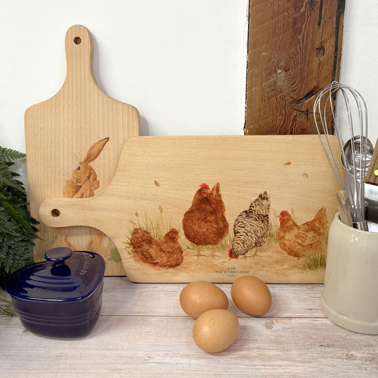 Handmade paddle board in Beech wood, featuring a water colour Hen design with a hand tied luxury blue ribbon. perfect chopping board, charcuterie board, serving board and chopping board. 
