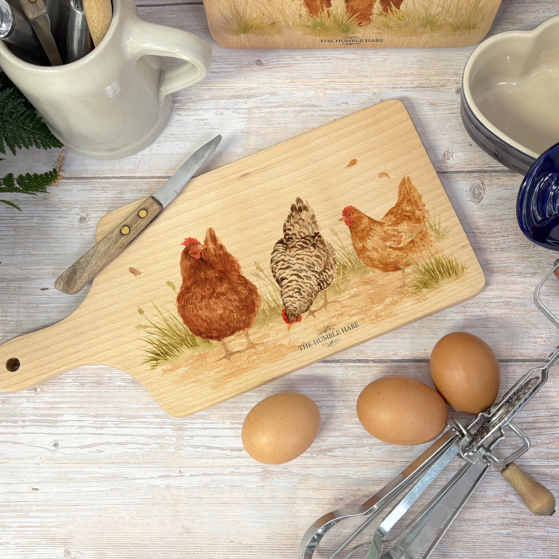 Handmade paddle board in Beech wood, featuring a water colour Hen design with a hand tied luxury blue ribbon. perfect chopping board, charcuterie board, serving board and chopping board. 