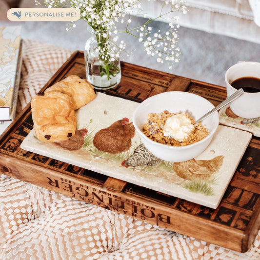 A handmade marble sharing platter being used to serve breakfast and coffee. The platter has a watercolour design featuring four hens in a farmyard.