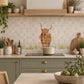 British countryside marble mural above a traditional range cooker, featuring a highland cow 