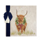 A large square marble placemat with a watercolour highland cow wearing a Christmas wreath around his neck. The platter is gift wrapped with a navy blue bow and paper tag.
