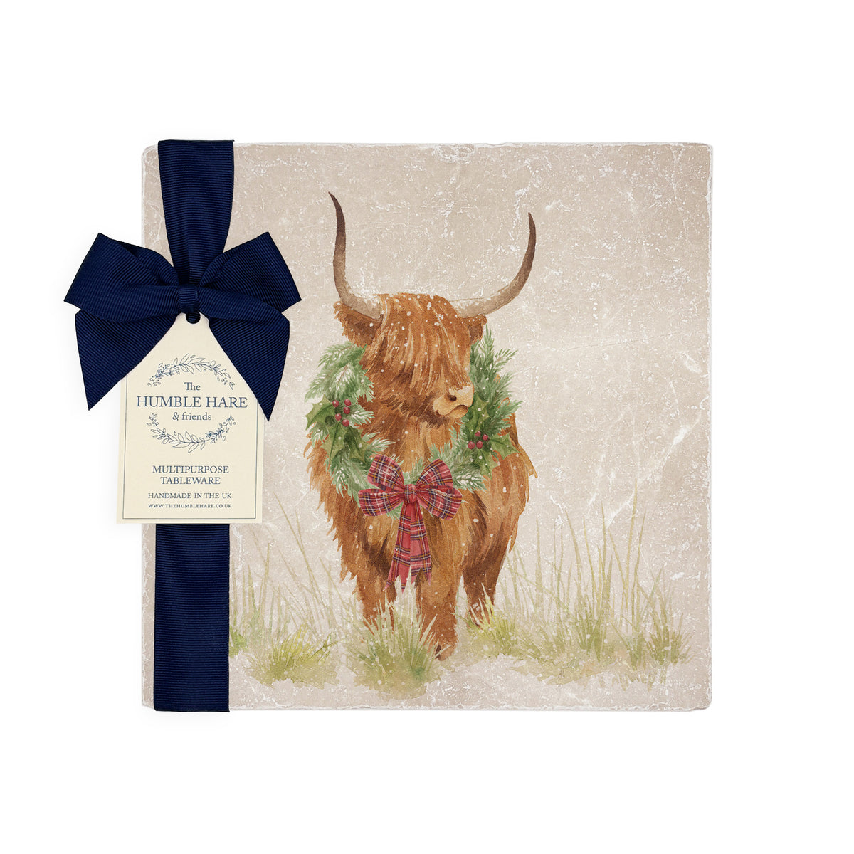 A square medium marble platter featuring a watercolour illustration of a Highland cow with a Christmas wreath around his neck. The platter is wrapped with a navy blue bow and paper tag.