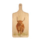 Handmade paddle board in Beech wood, featuring a painted Highland cow with a hand tied luxury blue ribbon. 