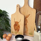 Handmade paddle board in Beech wood, featuring a water colour Highland Cow design with a hand tied luxury blue ribbon. perfect chopping board, charcuterie board, serving board and chopping board. 