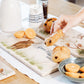 A highland cow sharing platter set on a breakfast table. The marble platter is personalised with a couple's names the their wedding date.