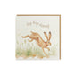 A greetings card reading Hip Hop Hooray in brown text above a leaping hare in a watercolour style. The card has a recyclable brown kraft envelope behind it.