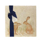 A multipurpose marble platter with a design featuring two hares facing each other about to touch noses, packaged with a luxurious dark blue bow and branded gift tag.