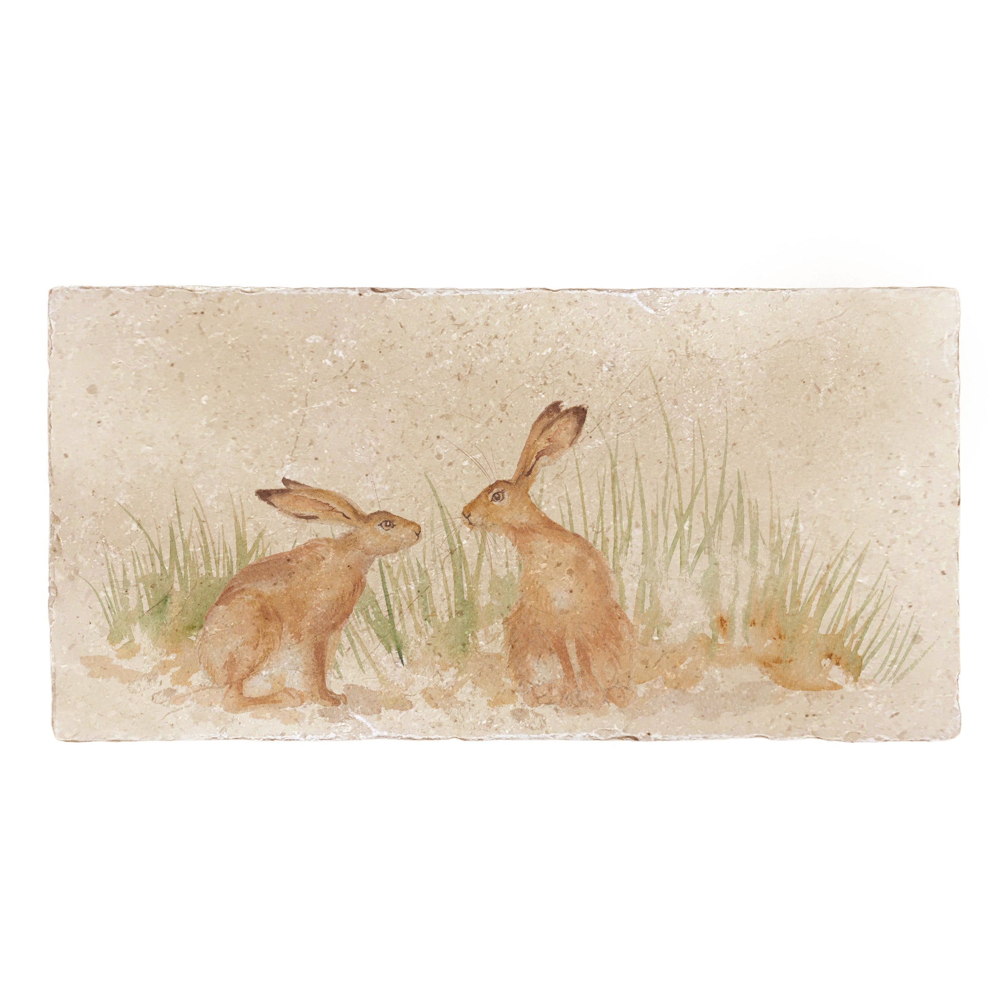 A handmade rectangle cream marble splashback tile featuring a watercolour countryside animal design of two hares in grass facing each other about to touch noses.