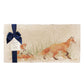 A multipurpose marble sharing platter with a fox and fox cub design, packaged with a luxurious dark blue bow and branded gift tag.