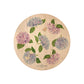 Round beech wood chopping board featuring a watercolour floral pattern of blue and pink hydrangea flowers and butterflies.