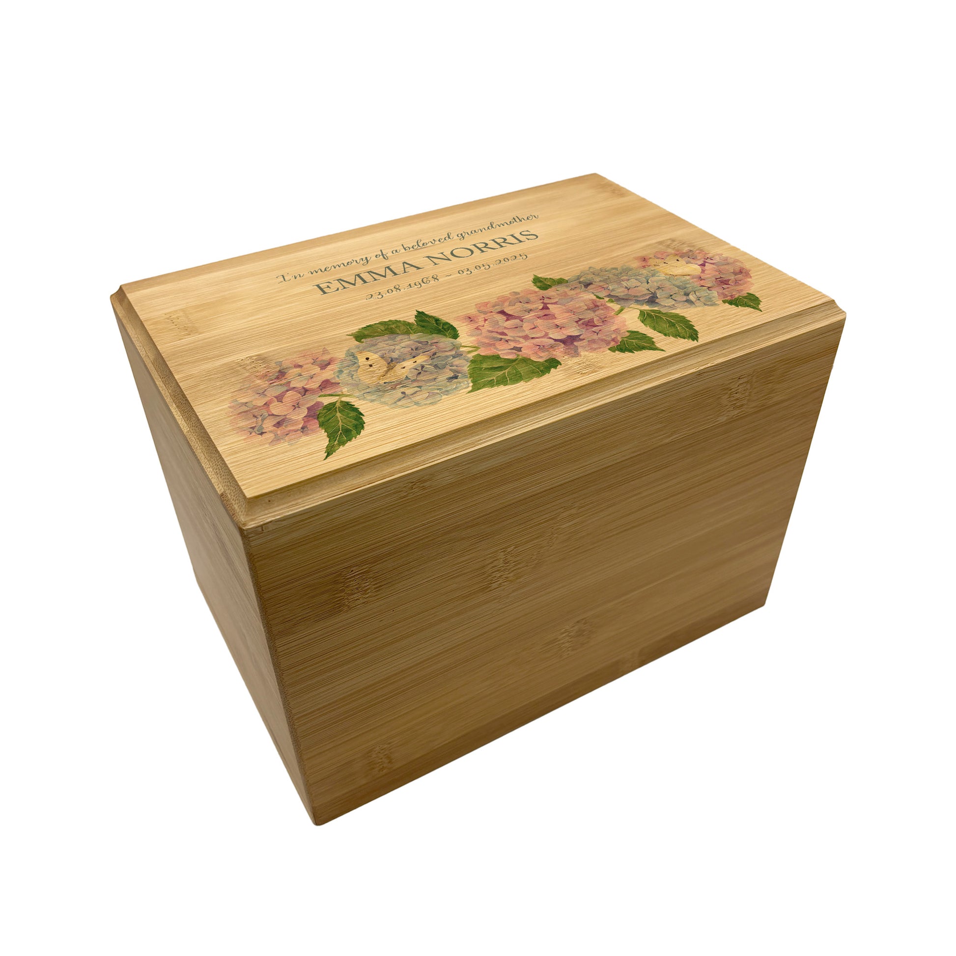 A beautifully crafted solid Bamboo wooden urn, personalised and finished with a soft watercolour design of Hydrangeas and butterflies for the person who loved flowers and being in the Garden. Thoughtfully made for either display or burial, this personalised urn can be customised to create a meaningful memorial. Perfect for holding ashes of a loved one or a beloved pet, it serves as a comforting tribute and keepsake. 