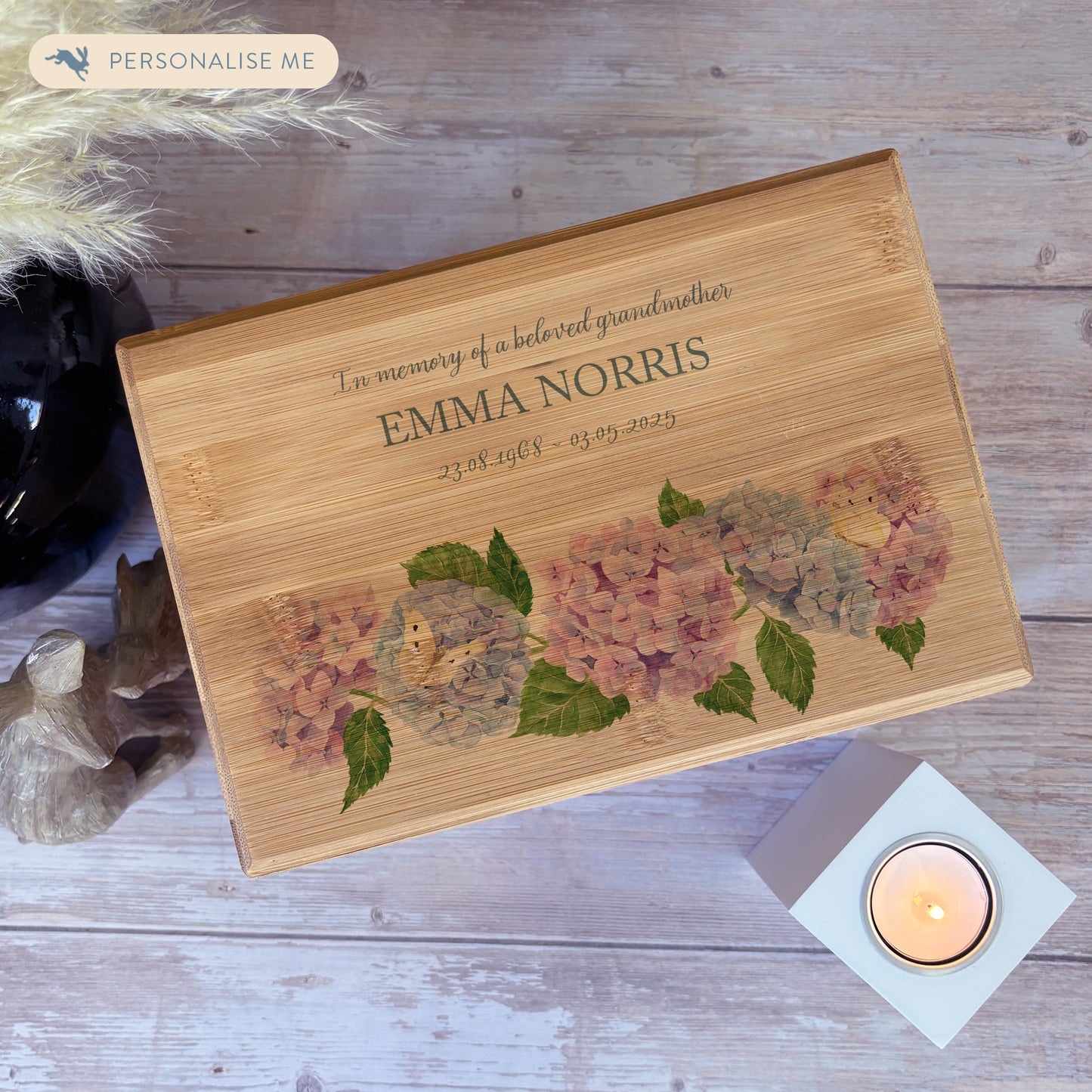 A beautifully crafted solid Bamboo wooden urn, personalised and finished with a soft watercolour design of Hydrangeas and butterflies for the person who loved flowers and being in the Garden. Thoughtfully made for either display or burial, this personalised urn can be customised to create a meaningful memorial. Perfect for holding ashes of a loved one or a beloved pet, it serves as a comforting tribute and keepsake. 